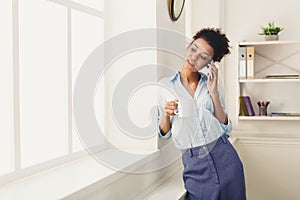 Business woman has phone talk near office window