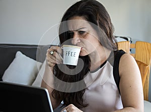 Business woman having coffee at home office desk
