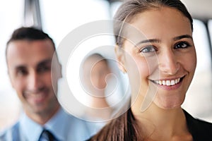 Business woman with her staff in background at office