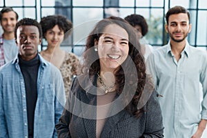 business woman with her staff in background at office photo