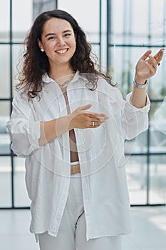 business woman with her staff in background at office photo