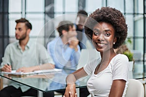 business woman with her staff in background at office photo