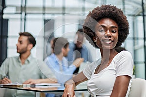 business woman with her staff in background at office photo