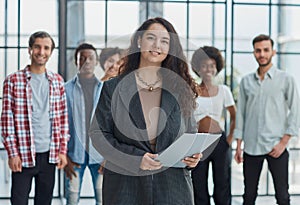 business woman with her staff in background at office photo