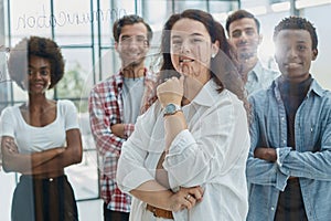 business woman with her staff in background at office photo