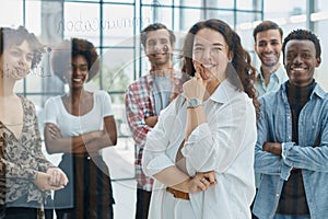 business woman with her staff in background at office photo