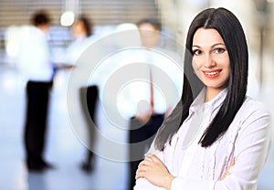 Business woman with her staff, people group in background