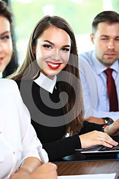 Business woman with her staff, people group in background