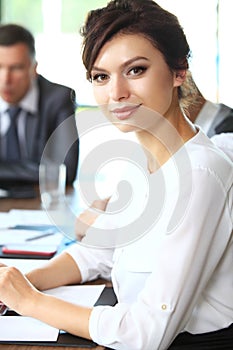 Business woman with her staff, people group in background