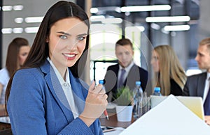 business woman with her staff, people group in background at modern bright office indoors.