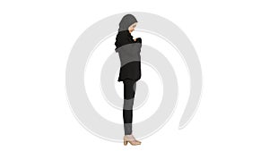 Business woman in hijab standing fixing her hijab on white backg