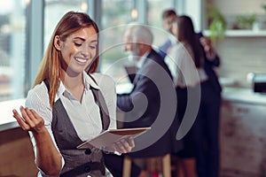 Business woman hold white blank paper. Young smiling.