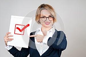 Business woman holding blank paper with check