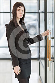 Business woman holding the door handle photo