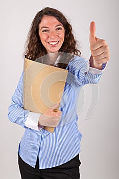 The business woman is holding a file in her hands