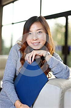 Business woman holding with folder in office