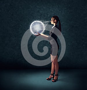 Business woman holding glowing planet earth