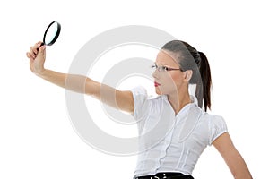 Business woman holding magnifying glass