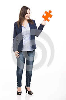 Business woman holding a puzzle piece