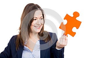 Business woman holding a puzzle piece