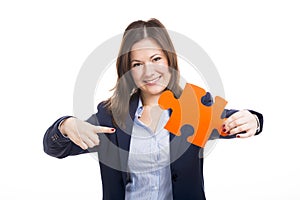 Business woman holding a puzzle piece