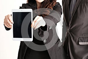 Business woman holding and showing black screen tablet