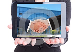 Business woman holding tablet with businesspeople handshake on s