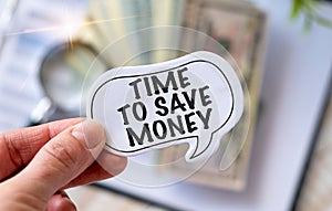 Business woman holding TIME TO SAVE MONEY text card, business concept