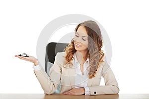 Business woman holding a toy car.