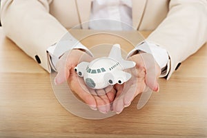 Business woman holding a toy plane