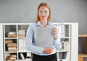 Business woman holding a writing tablet clipboard