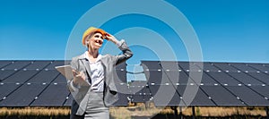 Business woman or investor inspecting her solar farm