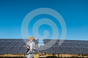 Business woman or investor inspecting her solar farm