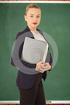 Business woman in a jacket with a folder in hands