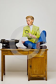 Business woman, journalist. Fashionable middle age blonde woman with short haircut in stylish clothes among retro