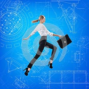 Business woman jumping over blueprint background.