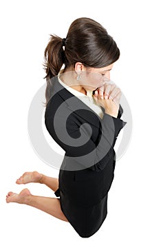 Business woman kneeling and praying