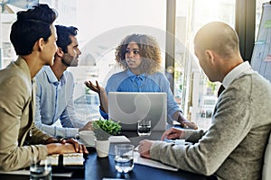 Business woman, laptop and coaching with team in meeting, presentation or conference at office. Female person talking to