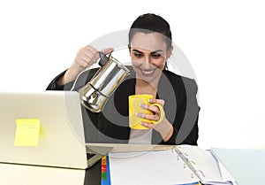 Business woman at laptop computer desk drinking coffee excited and anxious in caffeine addiction