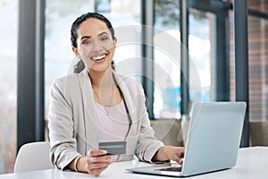 Business woman, laptop online shopping and portrait with happiness and credit card. Paying bills, happy worker and