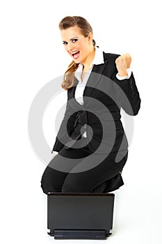 Business woman with laptop rejoicing her success