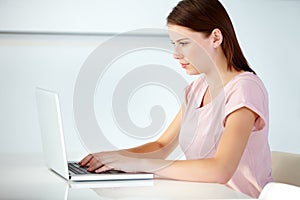 Business woman, laptop and typing in office at desk for online research, website review and planning social media