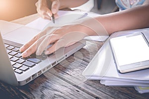 Business woman and laptop and write on notebook. in door office.