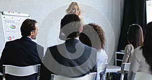 Business Woman Leading Presentation While Businesspeople Group Listening And Asking Questions, Communication On