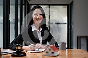 Business woman or legal advisor sitting wooden desk in office. Law, legal services, advice,Judge auction and real estate