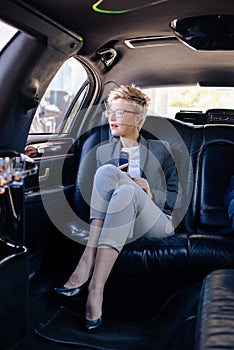 Business woman in limo sitting