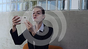 Business woman look into smart phone glass reflection and smarten up.