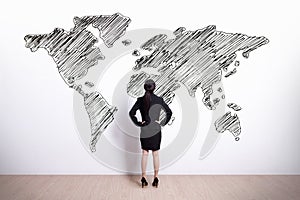 Business woman look world map