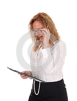 Business woman looking at her clipboard.