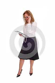Business woman looking at her clipboard.